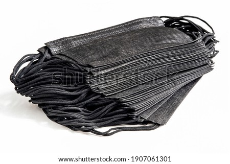 Set of black medical protective masks of 50 pieces on a white background isolated. The concept of masks for protection against influenza, smog, virus, coronavirus, and allergies.