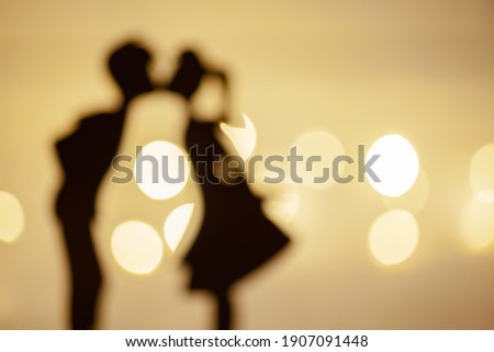 Valentine's Day poster, banner. Out of focus. Soft focus. Valentine's Day background. The silhouette of a kissing couple. Copy space.