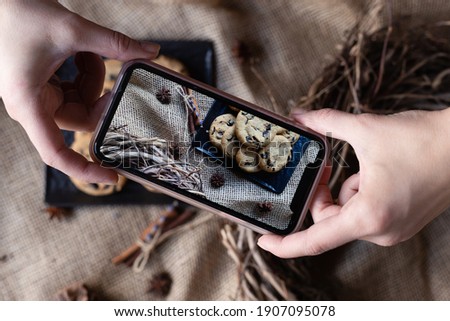 Phone with photo, biscuit, and different spices on burlap. Culinary blog, recipe template, online cooking courses. Top view. Flat lay.