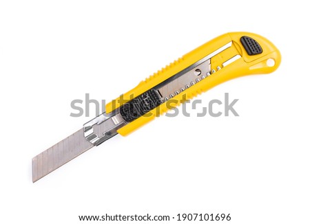 Yellow cutter knife isolated on white background Royalty-Free Stock Photo #1907101696