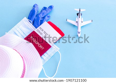 layout passport with ticket and pcr test medical mask on isolated background pandemic travel theme Royalty-Free Stock Photo #1907121100