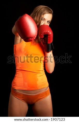 sporty girl in boxing gloves punching