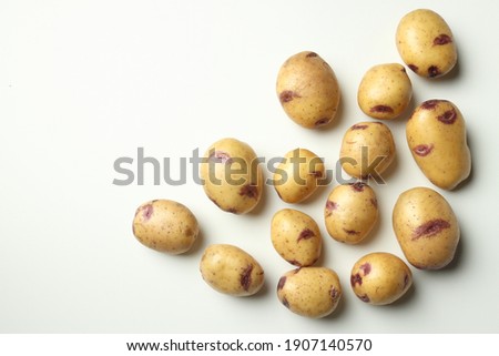 Copy space group raw potatoes on white gray background. Farm crop for sale in the market. Place for text.