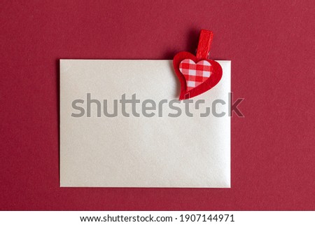 Red hearts on a background of red and white paper. Valentines Day card mock up