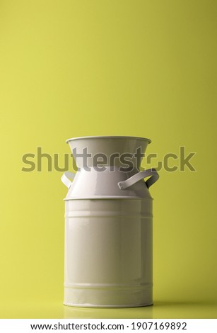 Metal white vase for flowers and design in the interior on a light background. Copy space.