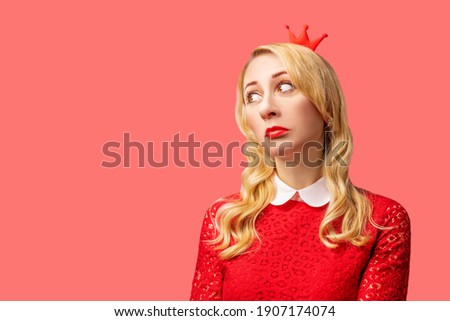 Beautiful girl with long hair on a red background for Valentine's day. toning. selective focus
