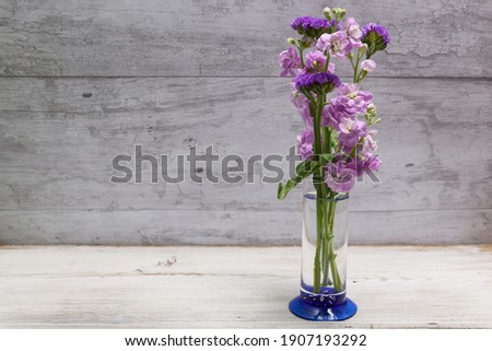 bouquet of statice and stock in a glass vase