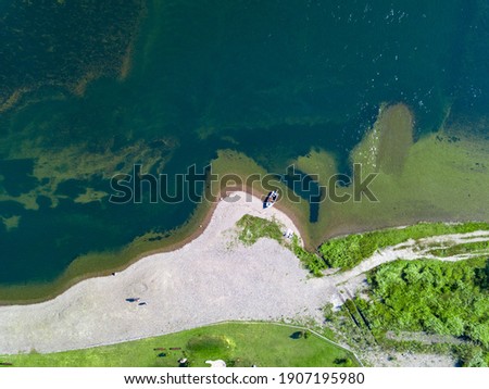 Boat on a riverbank shot from above