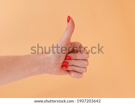 Female hand in a pose "like" on a background