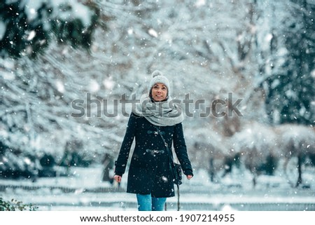 Shot of a beautiful woman spending time outdoors in the snow