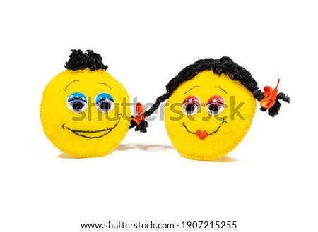 Homemade toys of lovers and cheerful yellow emoticons for Valentine's Day 