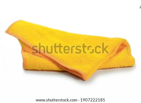 Yellow micro fiber towel isolated on white background. Clean, new yellow microfiber cloth isolated on white background Royalty-Free Stock Photo #1907222185