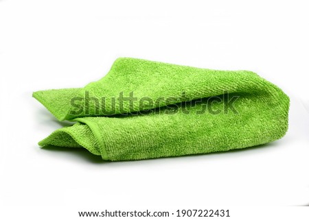 Green micro fiber towel isolated on white background. Clean, new green microfiber cloth isolated on white background Royalty-Free Stock Photo #1907222431