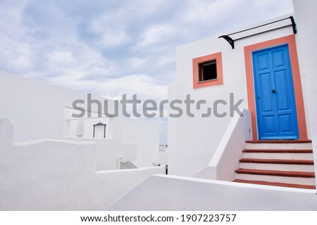 Sicilian white houses on Panarea Island, Aeolian Islands. White house with blue and orange door. Royalty-Free Stock Photo #1907223757