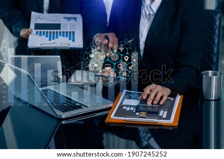 Double exposure business concept. Hands of business people working with documents and digital laptop  and network connection on virtual screen on office table, Digital marketing, Blurred background. Royalty-Free Stock Photo #1907245252