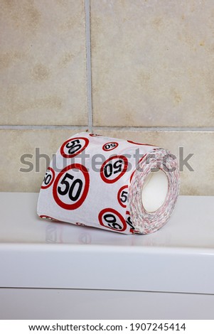 Roll of toilet paper with traffic signal speed limit 50