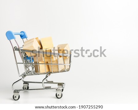 Online shopping and add to cart concept. Selective focus a bunch of wooden cubes in trolley isolated on white background.