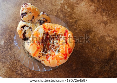 Pizza Bread and Chocolate Cheese Bread on a plate on top of textured grainy canvas table 