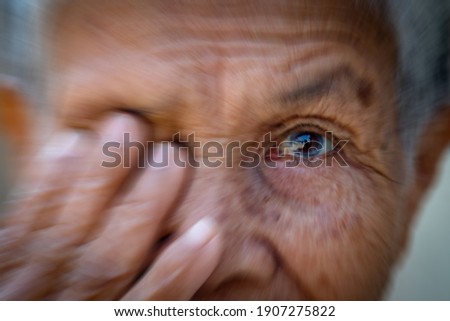 Blurred old women cover her eye use for health and medical concept background Royalty-Free Stock Photo #1907275822
