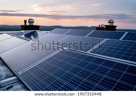 Solar panels located on the roof of the block. Green energy in modern city.
 Royalty-Free Stock Photo #1907310448