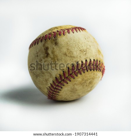 used and dirty baseball ball with red stitching