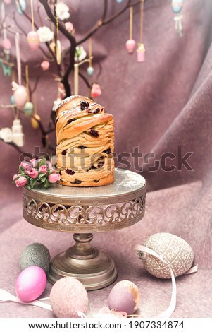 Traditional cupcakeTraditional cupcake Easter cake kraffin craffin with raisins on dark purple background. homemade cake Cruffin with dried fruits. Easter decoration table. easter desert celebration