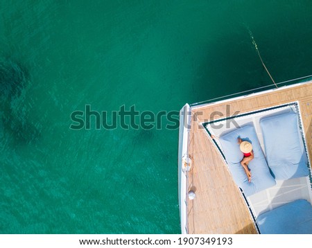 A woman sunbathing on a  catamaran boat,sunbathe