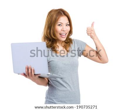 Young woman holding laptop making thumb up