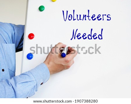 Business concept about Volunteers Needed with inscription on the sheet.
