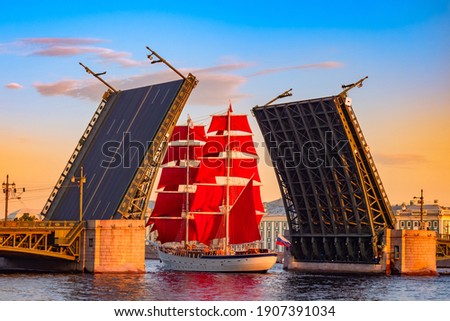 Saint Petersburg. Russia. A ship with scarlet sails passes under the Palace bridge. White nights in Saint Petersburg. Holiday Scarlet sails. The sailing ship on the Neva. Bridges Of St. Petersburg. Royalty-Free Stock Photo #1907391034