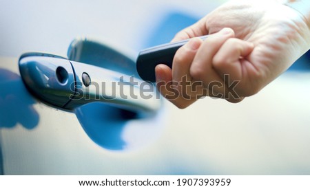 Male hand unlocking a car door