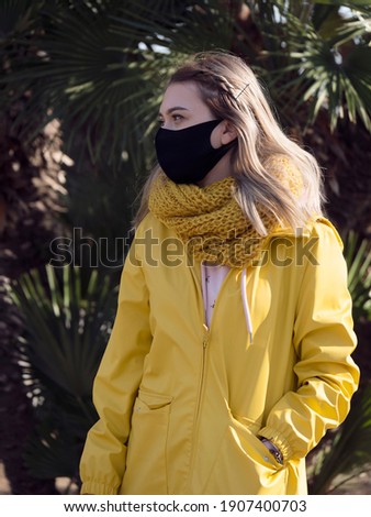 happy portrait beautiful cute young woman standing wear t-shirt making mask protection from virus epidemic or air pollution looking camera isolated, 
