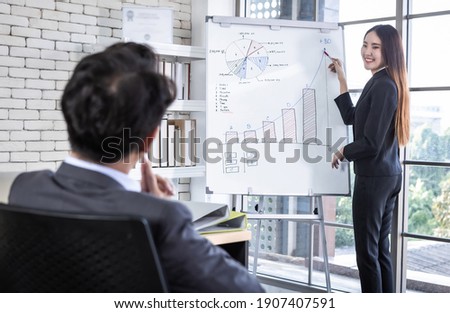 businessman and businesswoman boss Two partners presenting new project ideas and the increase in received bracelets background in office,female coach presenting successful business plan