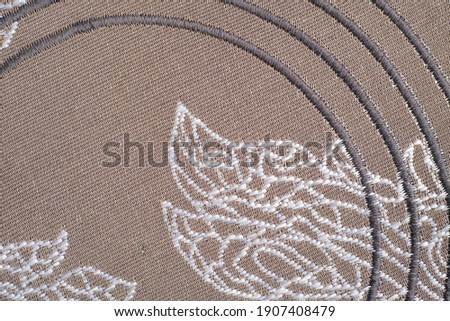 Zig-zag finishing stitch as an ornament on dense furniture fabrics for decor