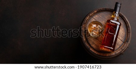 Scotch whiskey bottle, glass and old wooden barrel. With copy space. Top view flat lay Royalty-Free Stock Photo #1907416723
