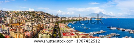 Naples, Italy: Panoramic view of the city and port with Mount Vesuvius on the horizon as  seen from the hills of Posilipo. Seaside landscape of the city harbor and golf on the Tyrrhenian Sea Royalty-Free Stock Photo #1907432512
