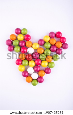 colored gums and candies on a white background