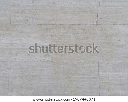 Wall of a building covered with Roman travertine slabs