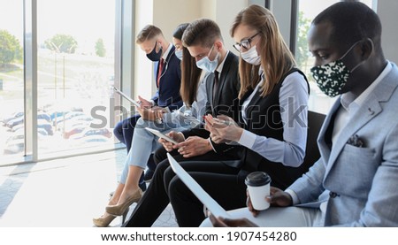 Stressful business people waiting for job interview with face mask, social distancing quarantine during COVID19 affect Royalty-Free Stock Photo #1907454280