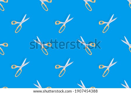 Scissors seamless pattern. Barber scissors on a blue background. 