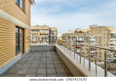 Empty terrace on modern new high-rise residential building in city. Royalty-Free Stock Photo #1907457670
