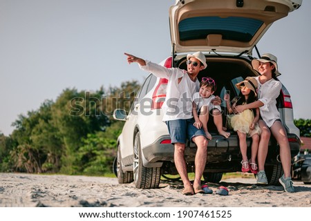 Happy asian family enjoying road trip with their favorite car. Parents and children are traveling the way to the sea or ocean.Holiday and travel family concept, Summer vacations. Royalty-Free Stock Photo #1907461525