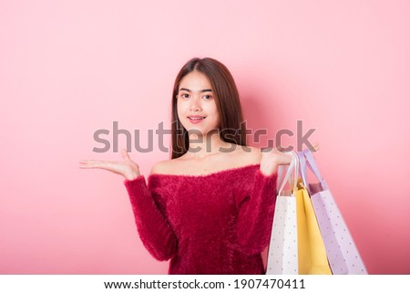 Cheerful Beautiful Young Woman in a Pretty mini dress with Shopping bags on pink background. Lifestyle and Summer Fashion. Shoping and Fashion. Winter fashion