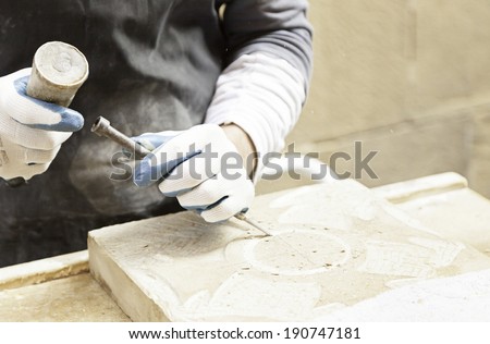 Man carving stone detail of a traditional craftsman working stone worker, crafts Royalty-Free Stock Photo #190747181