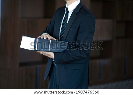Cropped image of lawyer holding law book
