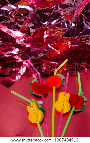 Vertical image of funny cocktail straws on the shiny pink background.Empty space