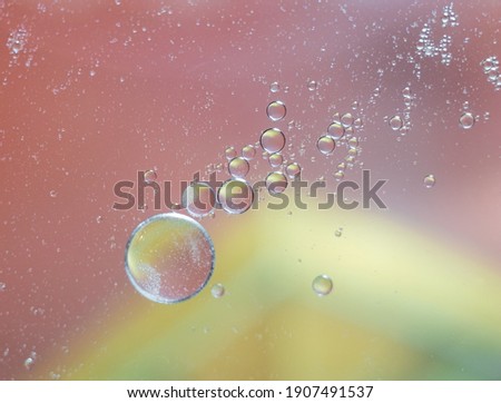 Abstract spheres on blurred background. Oil drops in a water.