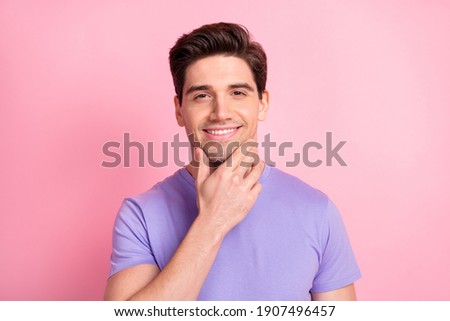 Portrait of attractive cheerful content groomed guy touching chin isolated over pink pastel color background Royalty-Free Stock Photo #1907496457