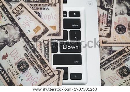 Keyboard with the word down and money around as a frame