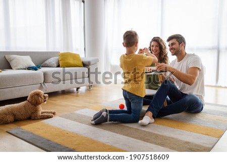 Happy young family having fun together at home. Happy childhood concept Royalty-Free Stock Photo #1907518609